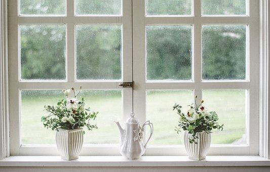 casement windows with decorative vases on sill