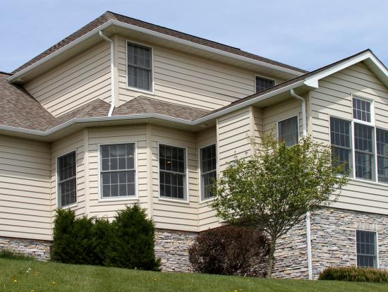 suburban home with manufactured stone veneer skirting