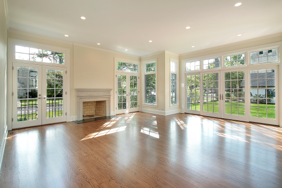 large living space surrounded by french patio doors with transoms