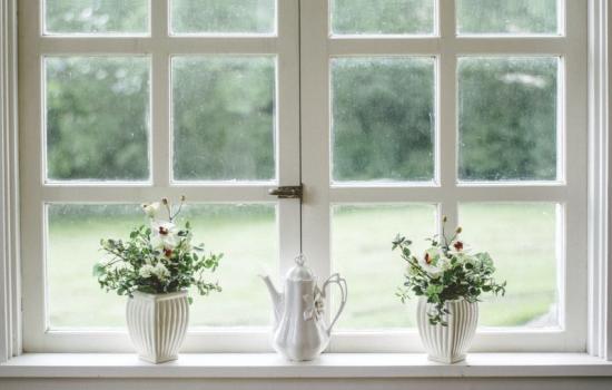 white wooden casement windows with vases on sill