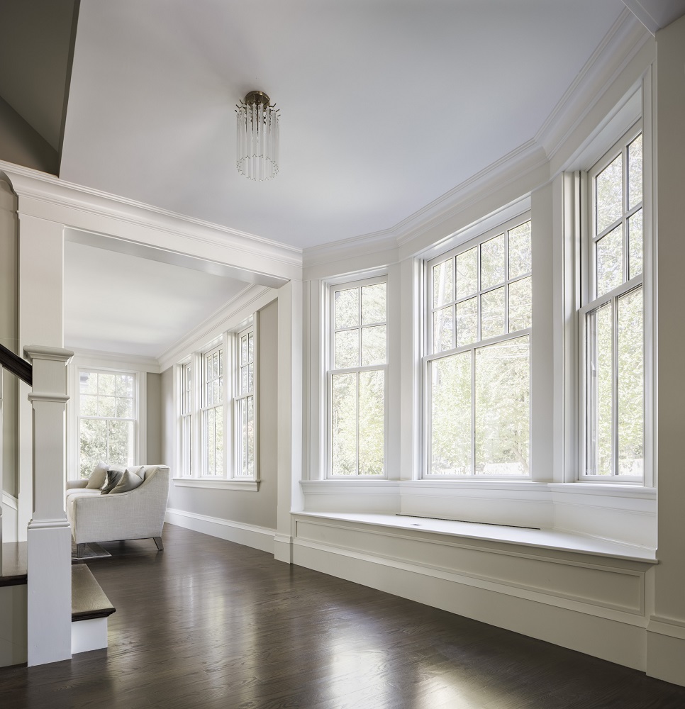 Bay windows with white framing and bench in contemporary living room