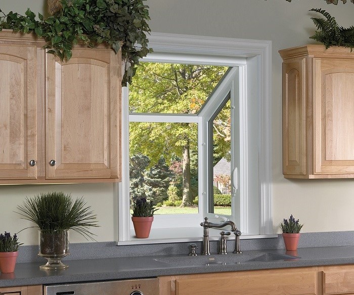 small garden window installed behind kitchen sink