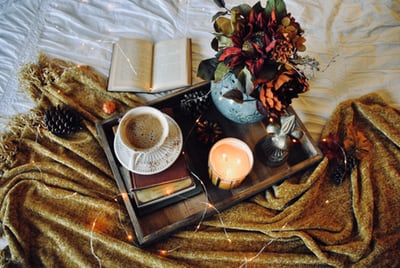 wooden tray with vase, candle, and coffee
