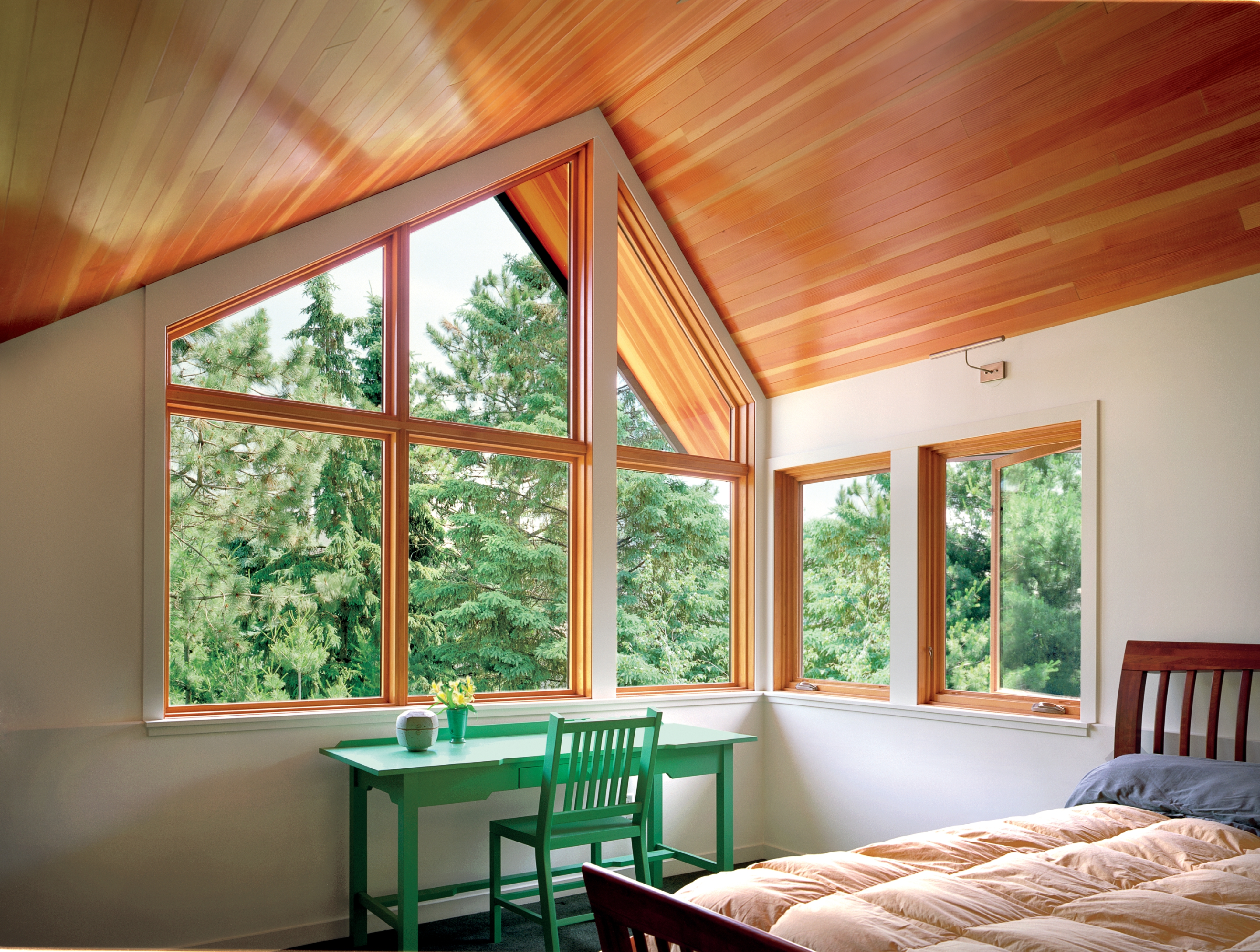 picture windows providing light and great views of treetops in upstairs bedroom